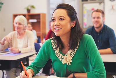 middle age woman with Pacific Islander features in class illustrating GED class at Goodwill TulsaWORKS Career Academy